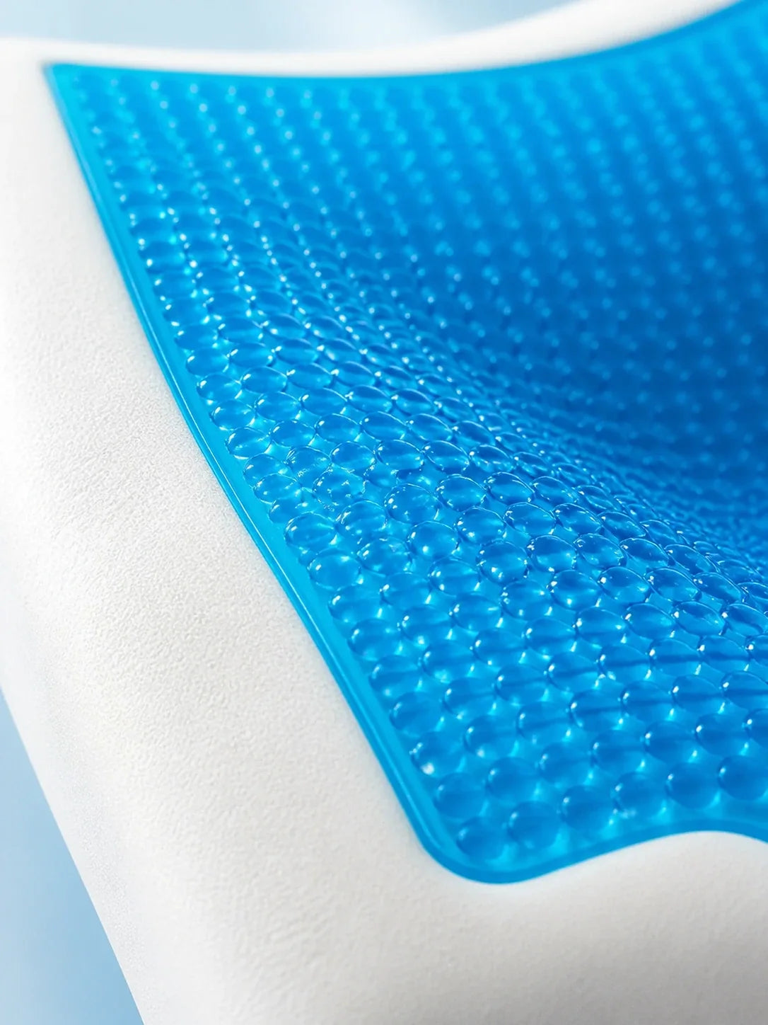 Macro detail of the bright blue dimpled gel panel and white foam border